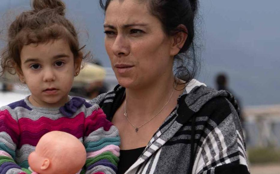 A family walks through the cars parked waiting to visit the tents of the Armenian Red Cross on September 26, 2023 in Kornidzor, Armenia. About 100,000 Armenians have fled the Nagorny Karabakh region, out of a population of 120,000, since Azerbaijan launched a military operation and regained control of the breakaway region. A family walks through the cars parked waiting to visit the tents of the Armenian Red Cross on September 26, 2023 in Kornidzor, Armenia. About 100,000 Armenians have fled the Nagorny Karabakh region, out of a population of 120,000, since Azerbaijan launched a military operation and regained control of the breakaway region.